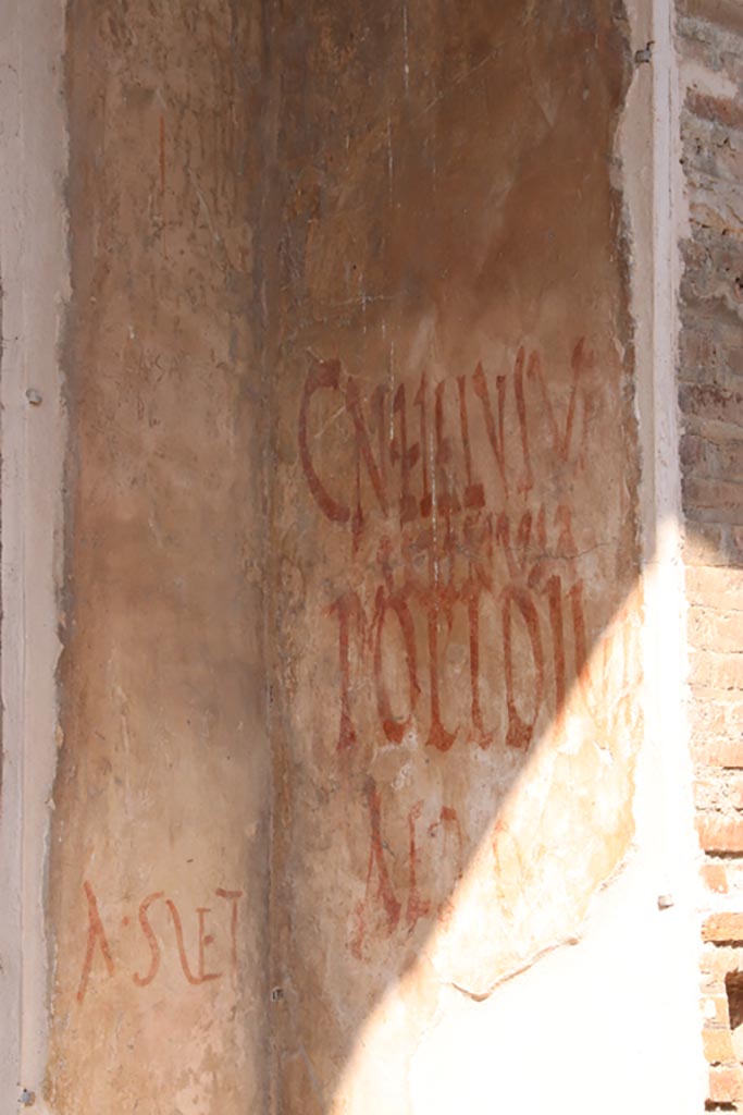IX.7.5 Pompeii. October 2023.
Graffiti outside workshop of Verecundus on east side of doorway. Photo courtesy of Klaus Heese.