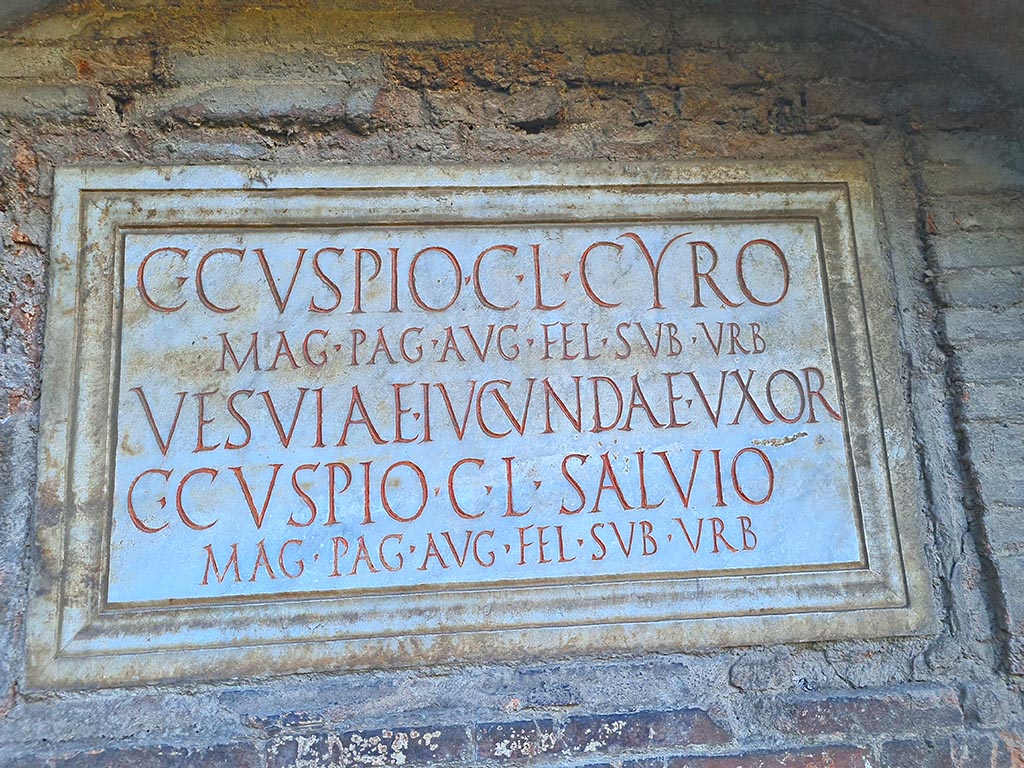 Pompeii Porta Nocera. October 2024. Tomb 17ES. Marble plaque with Latin inscription. Photo courtesy of Giuseppe Ciaramella.
C(aio) CVSPIO C(ai) L(iberto) CYRO
MAG(istro) PAG(i) AVG((usti) FEL(icis) SVB VRB(anis)
VESVIAE IVCVNDAE VXOR(i)
C(aio) CVSPIO C(ai) L(iberto) SALVIO
MAG(istro) PAG(i) AUG((usti) FEL(icis) SVB VRB(anis).
Caius Cuspius Cyrus and Caius Cuspius Salvius were both freedmen of Caius Cuspius.
Vesvia Iucunda the wife of C. Cuspius Cyrus would appear also to be free.
Both men would appear to have been magistrates/priests of the Pagus Augustus Felix Suburbanus.