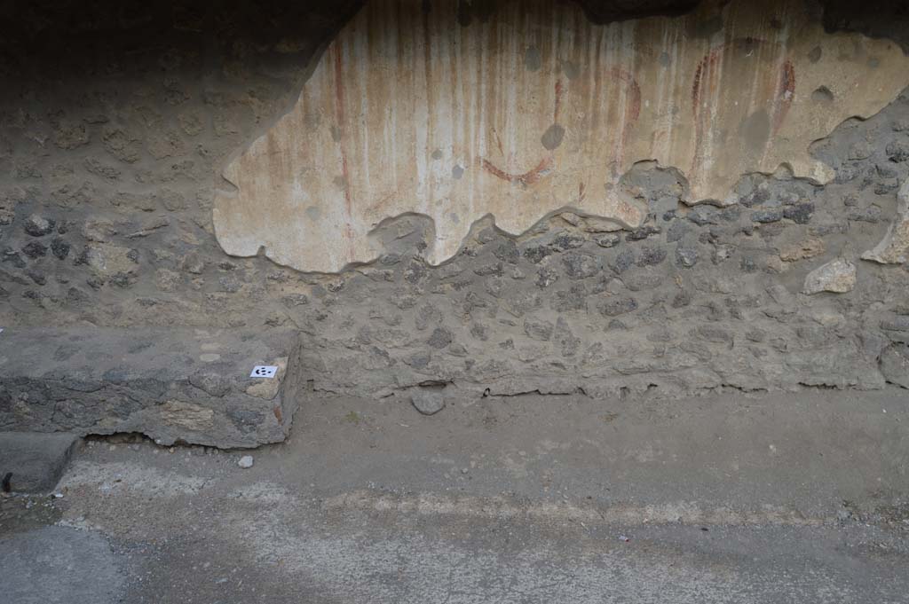 I.8.1 Pompeii. October 2018. West perimeter wall, with remains of lararium, white at bottom with serpent at the side of an altar.
Foto Taylor Lauritsen, ERC Grant 681269 DCOR.

