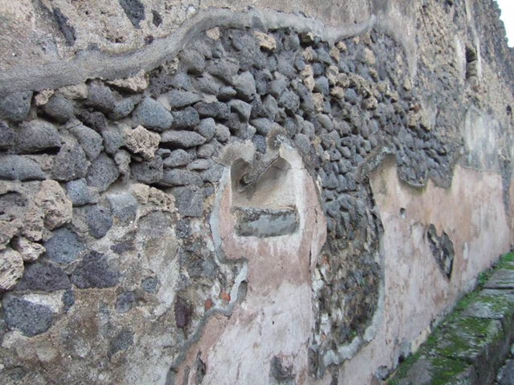 Street shrine at IX.2.12, Pompeii. December 2005. According to Breton, at the entry to the vicolo was a painting of two serpents, the most beautiful and the best preserved in Pompeii. 
The painting is surmounted by a small lararium and many inscriptions. See Breton, Ernest. 1855. Pompeia, decrite et dessine: Seconde edition . Paris, Baudry. (p. 315). According to Fiorelli, at this point was a painting of two large serpents approaching  a niche hollowed out of the wall. Underneath was the effigy of the altar among luxurious plants. Above the painting and continuing on the same wall, there remained various electoral programmes. See Pappalardo, U., 2001. La Descrizione di Pompei per Giuseppe Fiorelli (1875). Napoli: Massa Editore. (p. 142). See Fröhlich, T., 1991. Lararien und Fassadenbilder in den Vesuvstädten. Mainz: von Zabern. (F61). See Helbig, W., 1868. Wandgemälde der vom Vesuv verschütteten Städte Campaniens. Leipzig: Breitkopf und Härtel. (29).