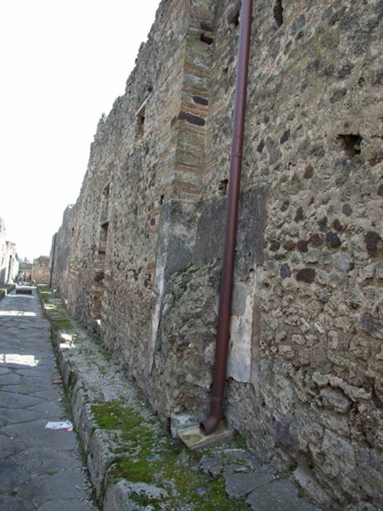 IX.2.19 Pompeii. March 2009. Location of street painting or shrine, looking south along west wall on Vicolo di Tesmo.