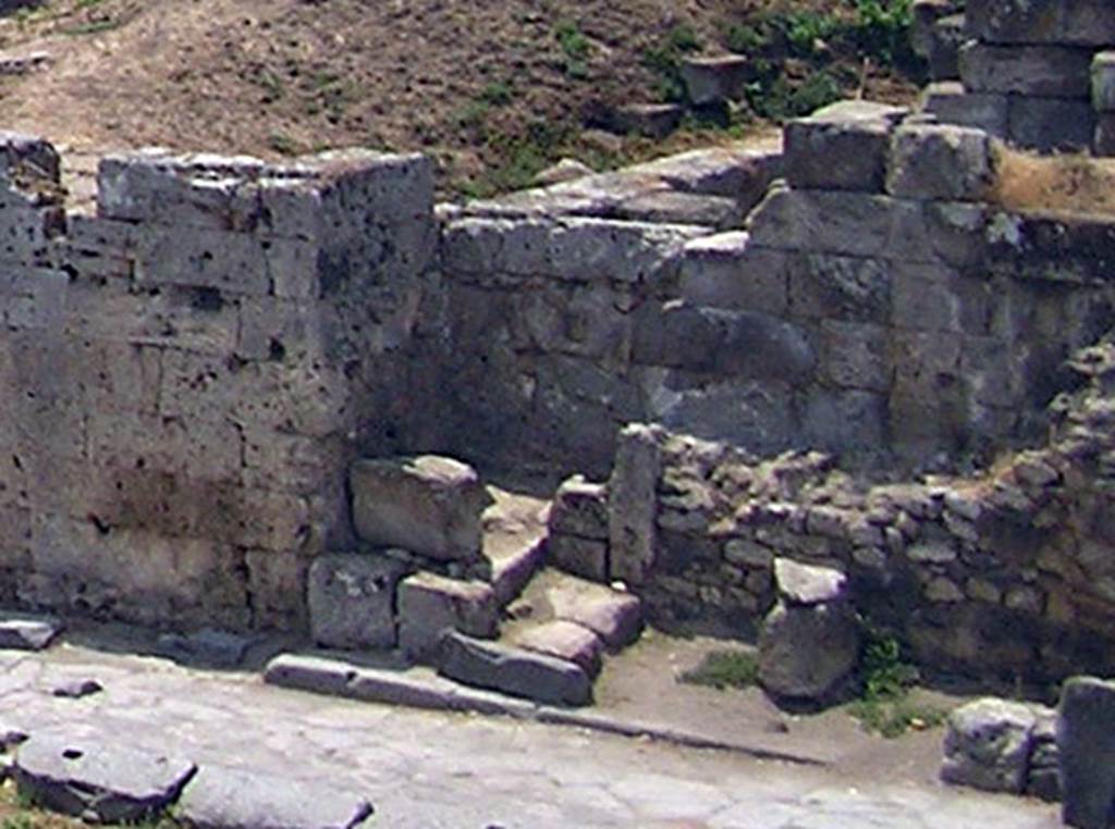 Two altars at Pompeii Vesuvian Gate. July 2003. According to Sogliano, the altars were in the south-west corner of the vestibule C, in a small recess just north of the gate stones.
One larger altar was in the wider part of the recess [d on the plan]. This would be the recess behind where the three large blocks are. Next to this altar was another much smaller altar [e on the plan], in a narrow part to the right (north) at the rear. This would be by the two small blocks with the upright stone next to them. See Notizie degli Scavi di Antichit, 1906, p. 97-100.