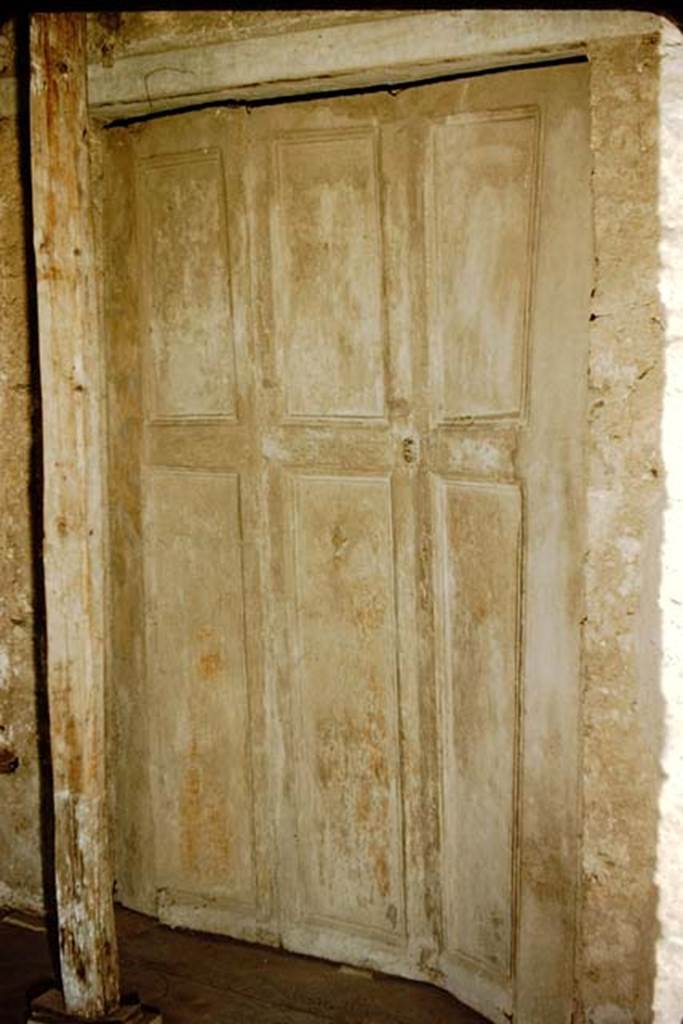 Villa of Mysteries, Pompeii. 1957. Room 16, cubiculum. Doorway with plaster cast of shutters at south end of portico P5. Photo by Stanley A. Jashemski.
Source: The Wilhelmina and Stanley A. Jashemski archive in the University of Maryland Library, Special Collections (See collection page) and made available under the Creative Commons Attribution-Non Commercial License v.4. See Licence and use details.
J57f0387