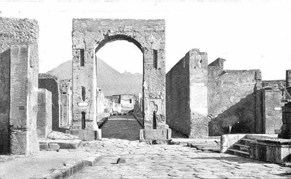 Arch of Caligula. About 1900. South side, looking north to Tower XI, the Tower of Mercurio.
Photo courtesy of Rick Bauer.
Dapres Thedenat, Les arcs de triomphe de Tibre au Forum et de la rue de Mercure ont t utiliss comme colonnes d'ascension pour les eaux. 
On voit mme au pied de l'arc de Mercure l'arrachement des deux fontaines enleves probablement en mme temps que les marbres du revtement.

According to Thedenat, the triumphal arches of Tiberius at the Forum and Via Mercurio were used as ascension columns for water.  
We can see also at the foot of the Arch of Mercury the site of the uprooting of the two fountains removed probably at the same time as the marbles of the cladding.
See Thedenat, H., 1906. Pompei: Vie Publique. Paris: Renouard. (Fig. 71, p. 128)