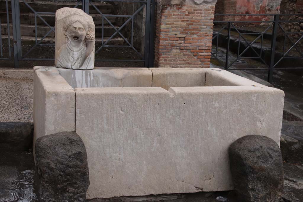 VII.9.67/68 Pompeii. October 2020. Looking north towards fountain with head of Fortuna with cornucopia, on north side of Via dellAbbondanza.
Photo courtesy of Klaus Heese. 
