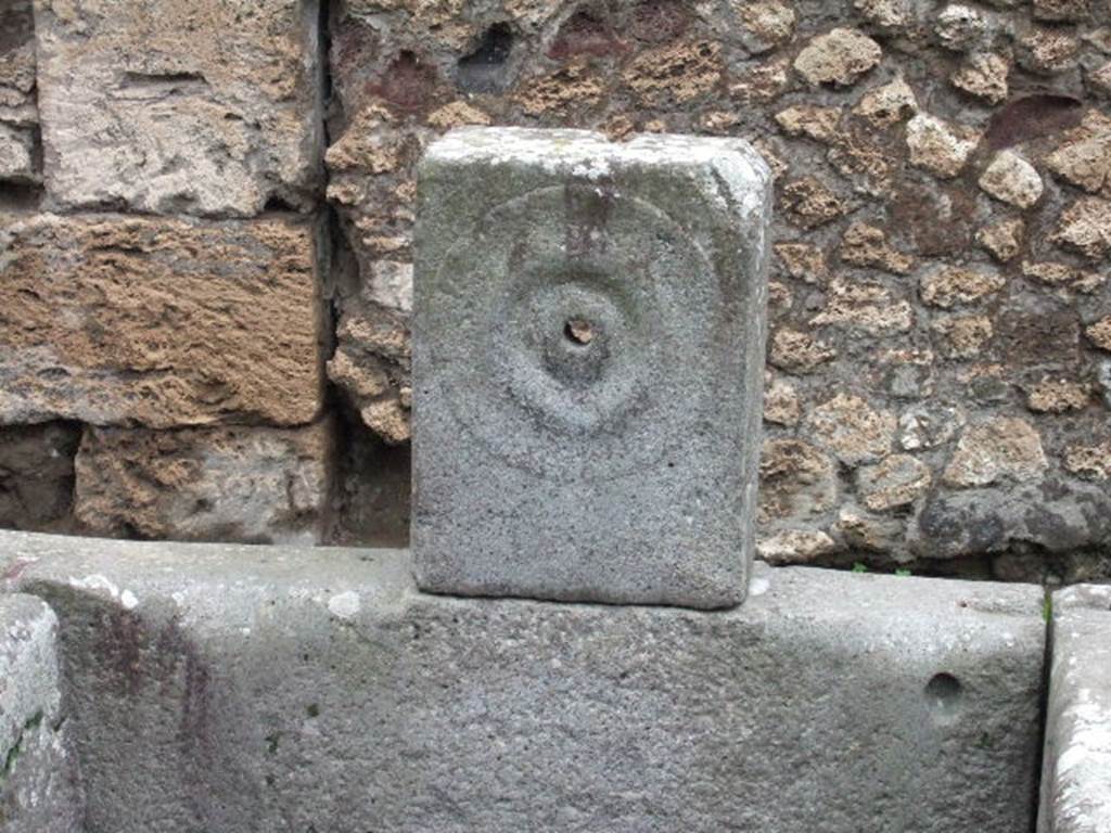 Fountain outside IX.10.2. December 2005. Relief of patera or plate, on pilaster.