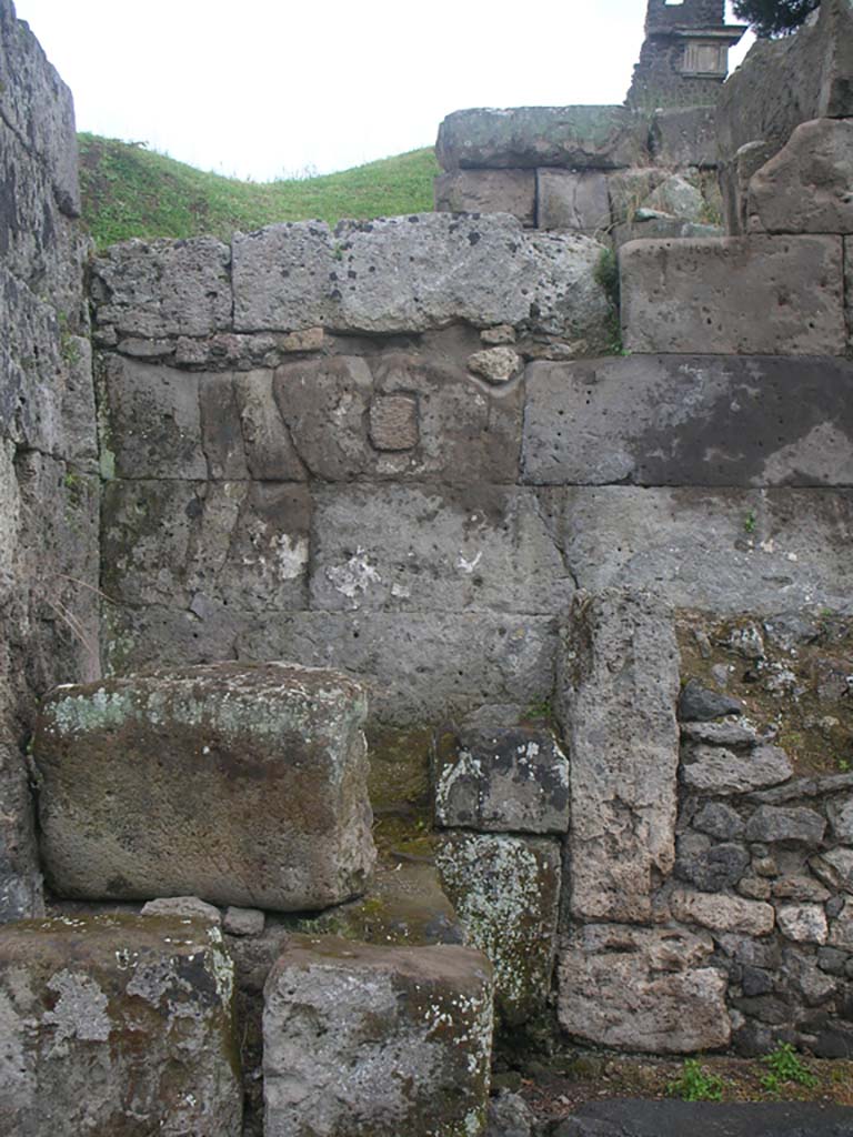 Vesuvian Gate Pompeii. May 2010. Detail from west wall at north end of gate. Photo courtesy of Ivo van der Graaff.
According to Sogliano –
“In the south-west corner [of area C, at the north end of the gate] there was a masonry altar [d on the plan, as mentioned above] with edges in relief and dressed entirely in plaster and with a painted representation now completely unrecognizable. Next to this altar there was another [e on the plan], much smaller, also with an edge in relief.” 
See Notizie degli Scavi di Antichità, 1906, p. 97-100.

