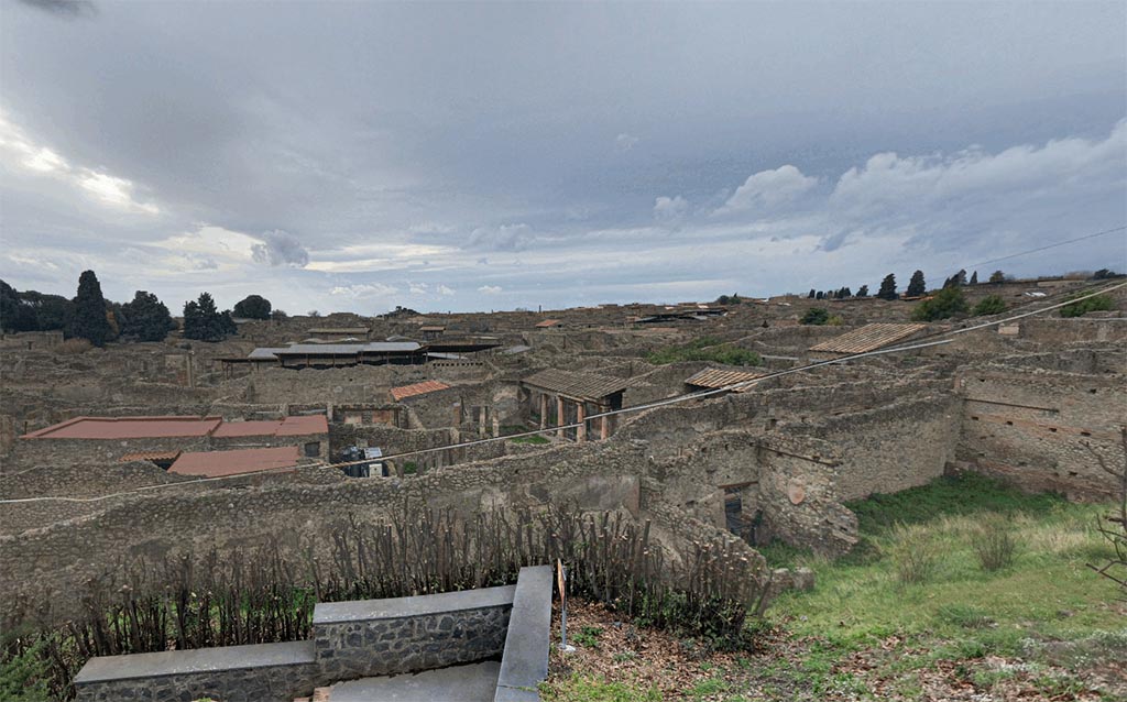 IX.7.12, 14 or 16 (?) Pompeii. 2017. 
Looking down from the Casina dell’Aquila towards an aedicula lararium in the north-west corner of the garden area “e”, on the right in the photo.
Photo courtesy of Google Earth.
Due to the fact that the area has not been fully excavated, it is not known whether this garden area belongs to IX.7.12, 14 or IX.7.16 or any other house in IX.7 entered from south or east side of Insula and still unexcavated.


