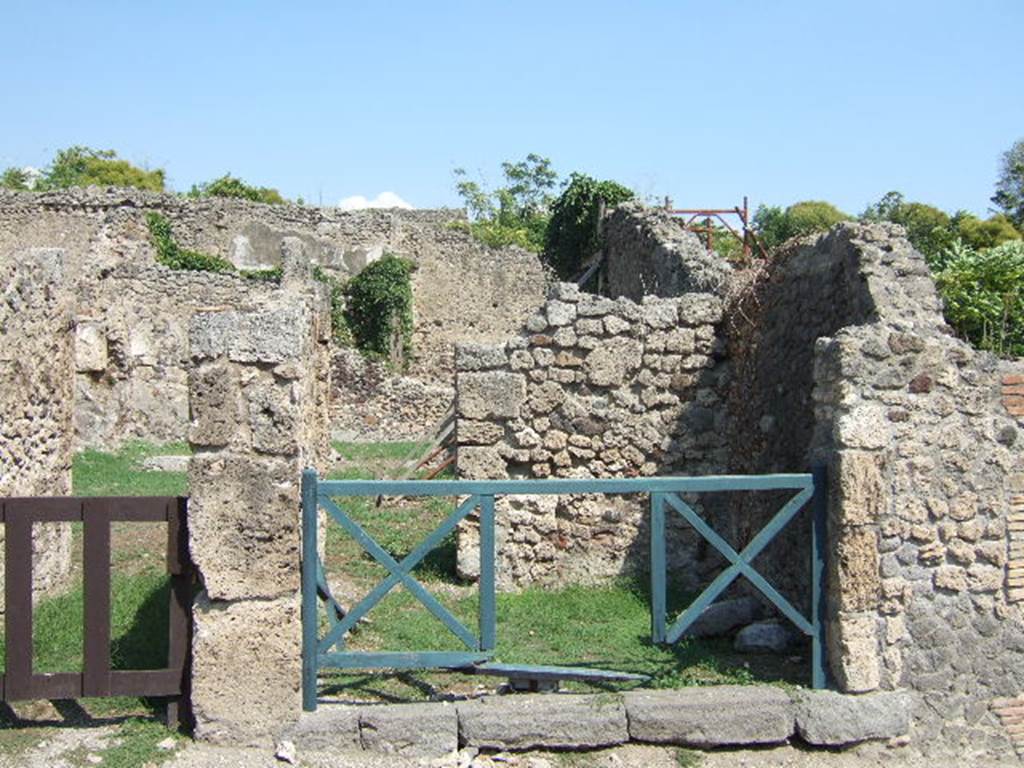 I.2.2 Pompeii. May 2005. 
Looking east into shop room with a rear door into the atrium of the house at I.2.3.          

Warscher described this as – “I.2.2 taberna communicante con la casa No.3”.
See Warscher T., 1935. Codex Topographicus Pompeianus: Regio I.2. Rome:DAIR.          
                                                                    
