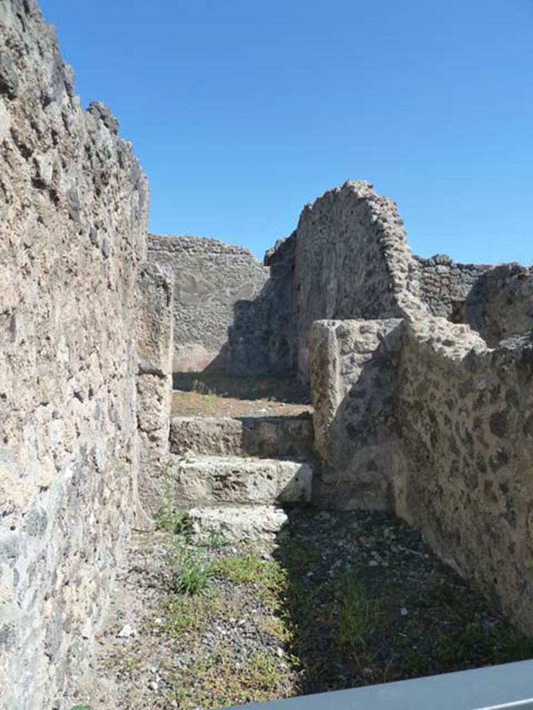 I.2.9 Pompeii. September 2015. Narrow shop connected by three steps in the east wall to the atrium of I.2.10. According to Warscher,
I.2.9 “angusta bottega, che per tre gradini aveva accesso nella casa contigua”.
See Warscher T., 1935. Codex Topographicus Pompeianus: Regio I.2. (after no.20), Rome: DAIR, whose copyright it remains. 
