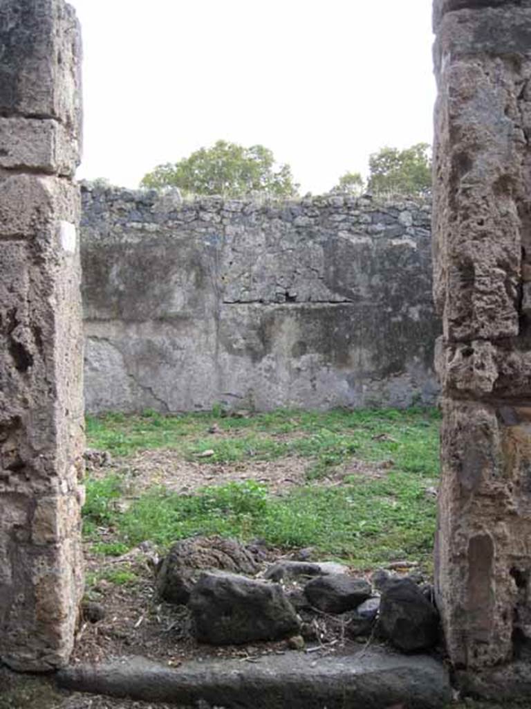 I.2.15 Pompeii. September 2010. Looking south to entrance doorway.
Photo courtesy of Drew Baker.
According to Warscher, quoting Fiorelli, she wrote  I.2.15, una casa che apparteneva a persona di umile condizione e che ricorda la casa primitiva di Pompei: consiste dellatrio a, due cubicoli e di una fauce che menava alla cucina, alla stalla, aduna apotheca, alla latrina, ed a una gradinata di fabbrica per le stanze superiori.
See Warscher T., 1935. Codex Topographicus Pompeianus: Regio I.2. Rome: DAIR.
(translation: "I. 2.15, a house that belonged to a person of humble condition and reminiscent of primitive houses of Pompeii: consisting of an atrium a, two cubiculae, and a corridor that led to the kitchen, to the stable, and to a storeroom, to the latrine, and to a masonry staircase to the upper rooms.) 
