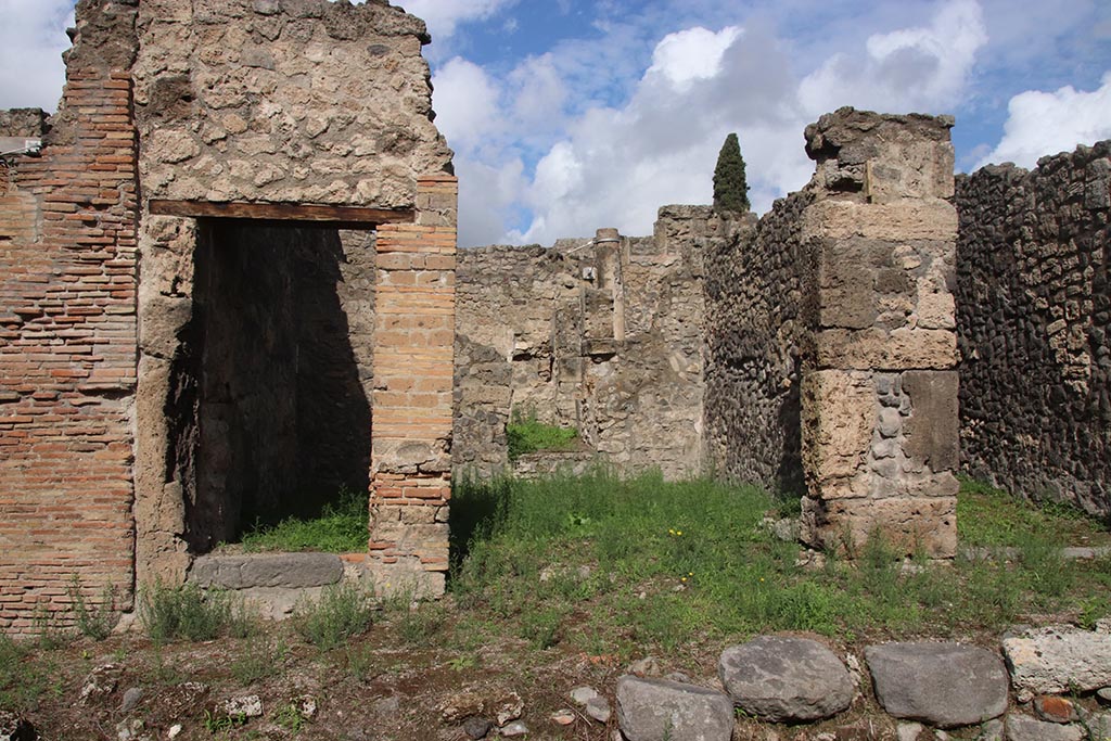 I.2.26 Pompeii. October 2024. 
Looking north towards entrances to I.2.26 on left, I.2.25 in centre, and I.2.24 on right. Photo courtesy of Klaus Heese.
