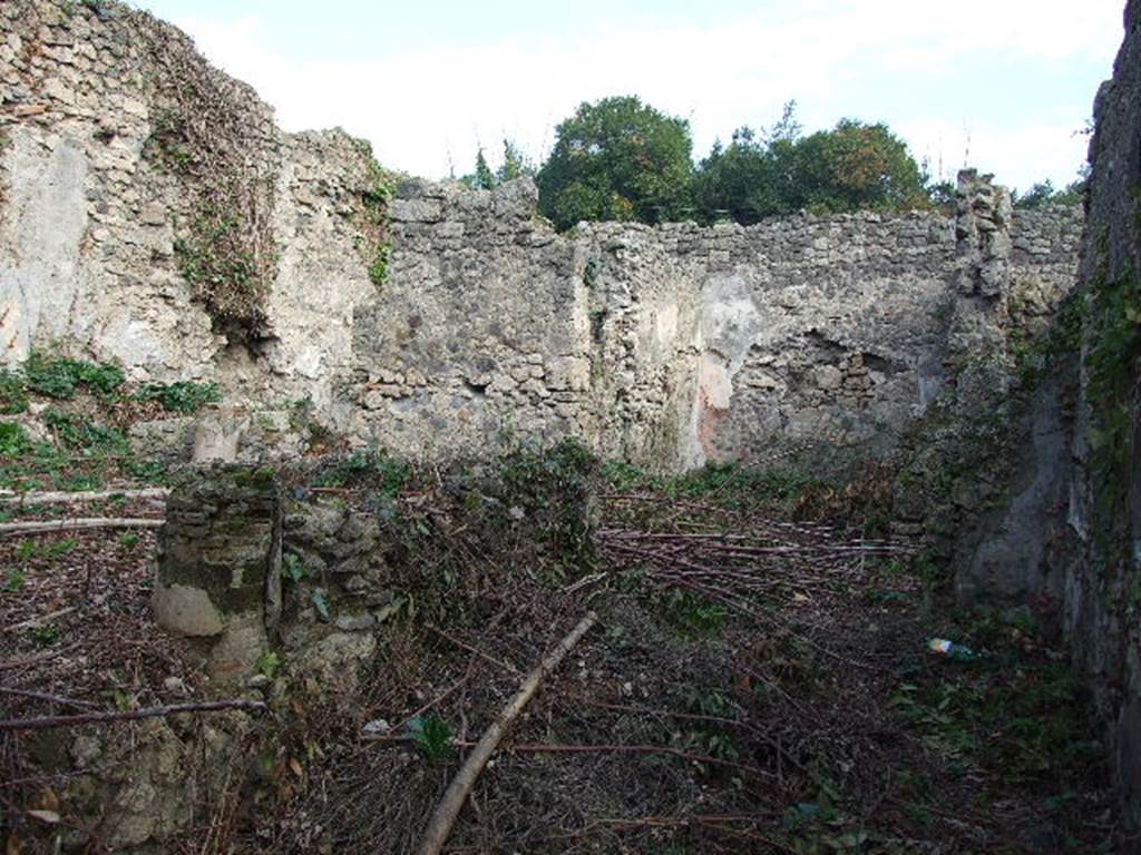 I.2.28 Pompeii. December 2006. Looking east along the south portico towards the large triclinium. The large triclinium would have been on the right of the picture, and kitchen area on the left.
