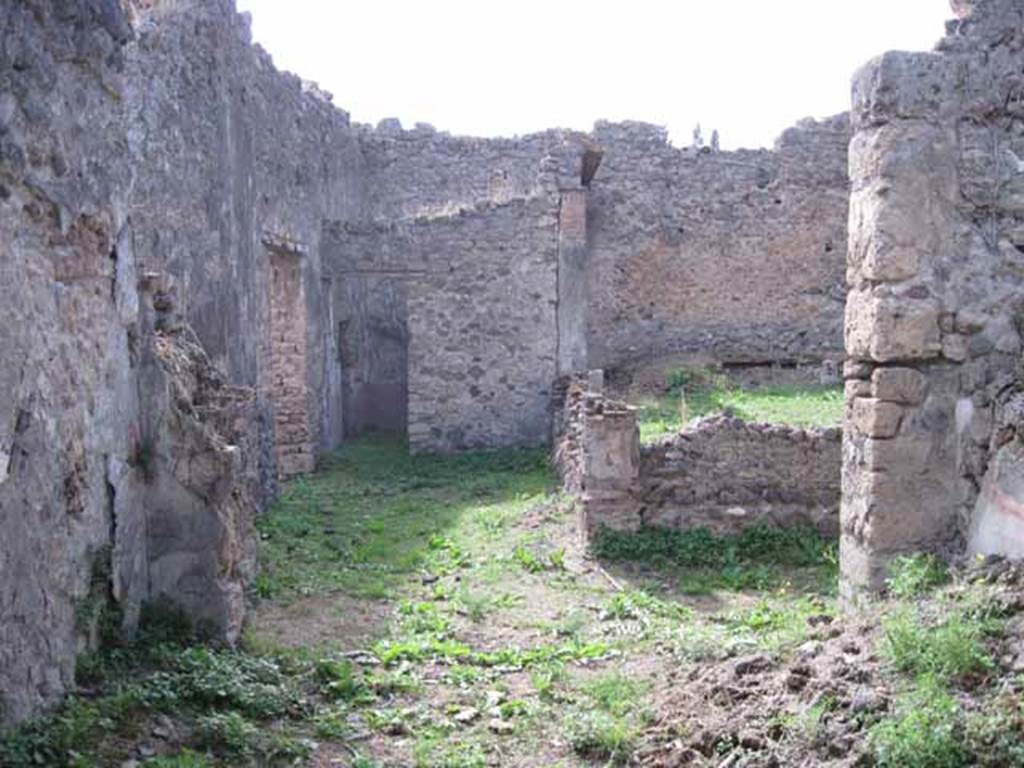 I.2.28 Pompeii. September 2010. Looking west from large triclinium onto south-east portico of garden area. Photo courtesy of Drew Baker.
