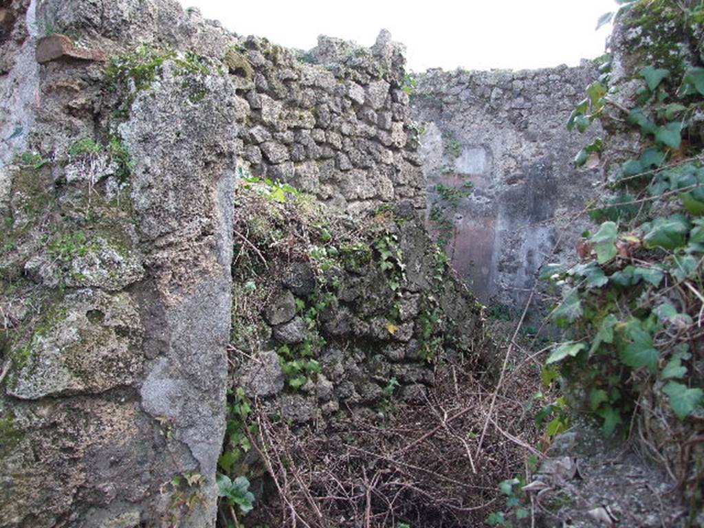 I.2.28 Pompeii. December 2006. Looking south into doorway in corridor on east side of atrium. Corridor with steps to upper floor, bench and doorway to room, on its east side.


