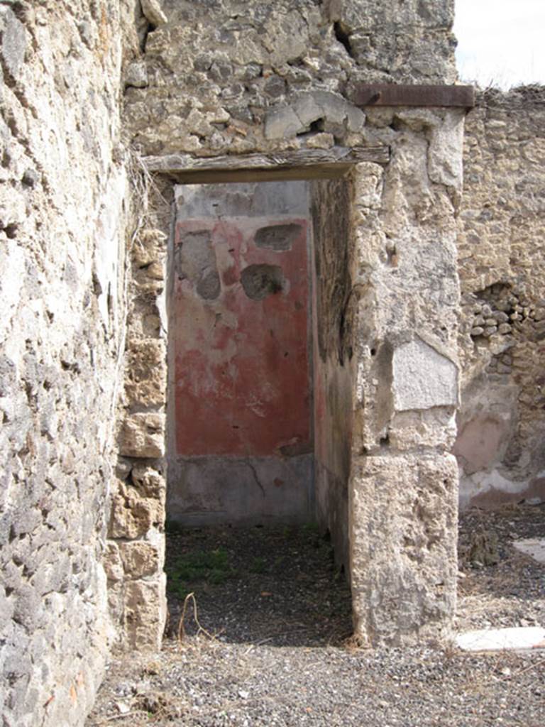 I.3.3 Pompeii. September 2010. Looking east towards doorway in north-east corner of atrium.  Photo courtesy of Drew Baker.
According to Fiorelli, this doorway led to the triclinium, the walls were simply decorated. 
Each wall was divided into three compartments, two painted red and one yellow. These walls were adorned with pictures of fish and fruit. 
See Pappalardo, U., 2001. La Descrizione di Pompei per Giuseppe Fiorelli (1875). Napoli: Massa Editore. (p. 38)
See BdI, 1874, p.178.
