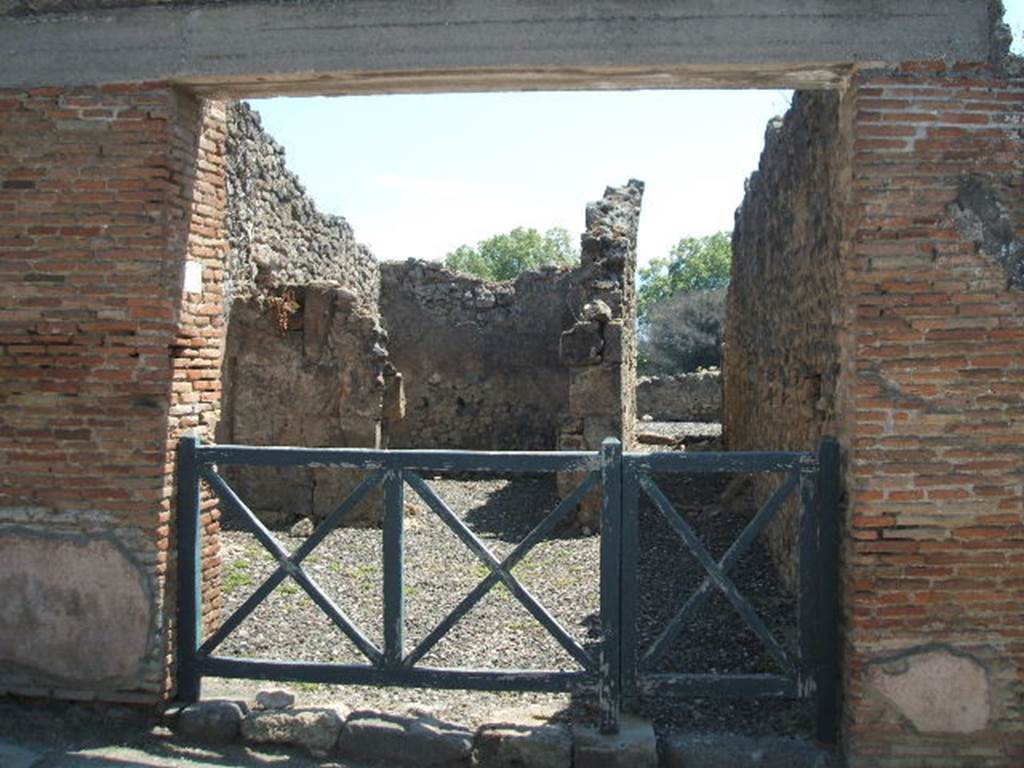 I.3.14 Pompeii. May 2005. Entrance, looking south into shop, with rear room and corridor. On the pilaster on the left side, Fiorelli was able to read the following inscription written in red. Even then it had almost totally vanished:
VATIAM   AED(ilem)
VERVS   INNOCE(n)S   FACIT
PAPILIO    [CIL IV 1080]
See Pappalardo, U., 2001. La Descrizione di Pompei per Giuseppe Fiorelli (1875). Napoli: Massa Editore.(p. 39)

Also on the pilaster on the left side, written in red, was:
Q(uintum)  POSTVMIVM  PROCV(lu)M
AED(ilem)  O(ro)  V(os)  F(aciatis)  SEXTILIVS  VERVS  FACIT [CIL IV 1081]
Found 19th July 1853. PAH II. 568.
See Pagano, M. and Prisciandaro, R., 2006. Studio sulle provenienze degli oggetti rinvenuti negli scavi borbonici del regno di NapoliNaples : Nicola Longobardi. (p.169) 
According to Della Corte, both these inscriptions were written on the left side of the entrance. See Della Corte, M., 1965.  Case ed Abitanti di Pompei. Napoli: Fausto Fiorentino. (p.266)

