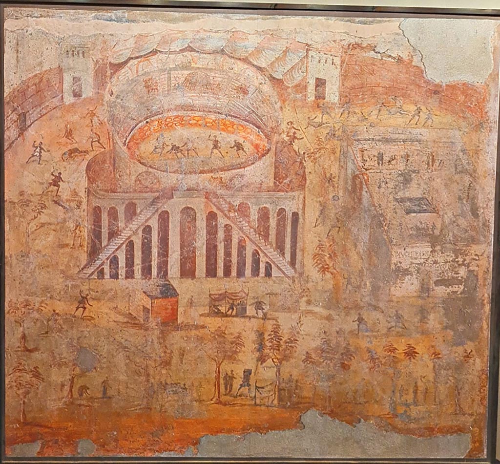 I.3.23 Pompeii. Photo taken May 2021, courtesy of Giuseppe Ciaramella. Rear wall of the peristyle. 
Painting of “Riot in the Amphitheatre” depicting the fight between the Nucerians and the Pompeians. 
Now in Naples Archaeological Museum. Inventory number 112222.
