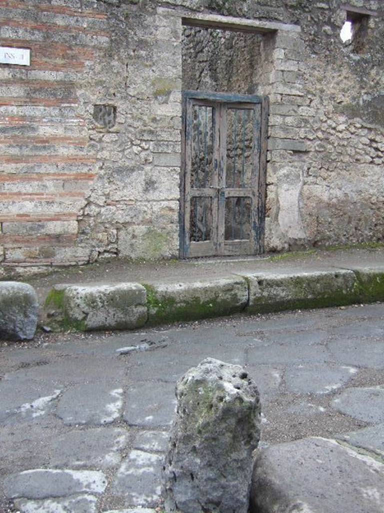 I.3.24 Pompeii. December 2006. Entrance on corner of  Vicolo del Menandro.  According to Della Corte, on the wall on both sides of the entrance were paintings of Mercury and Hercules. He thought the house belonged to the unknown Capella, because of the graffiti, still partly legible in the 1960s. On the left of the entrance:

L(ucium)  Ceium  Secundum  aed(ilem)
Cape
lla  rog(at)       [CIL IV 2993g]       

Capella  va(le)      [CIL IV 3200aa] and Note 3 on p.269.
See Della Corte, M., 1965.  Case ed Abitanti di Pompei. Napoli: Fausto Fiorentino. (p.269)
