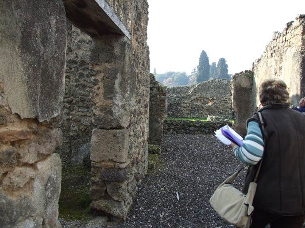 I.3.25 Pompeii. December 2006. Looking west across atrium area towards peristyle. The doorway to south, on the left, leads into shop at I.3.26.
