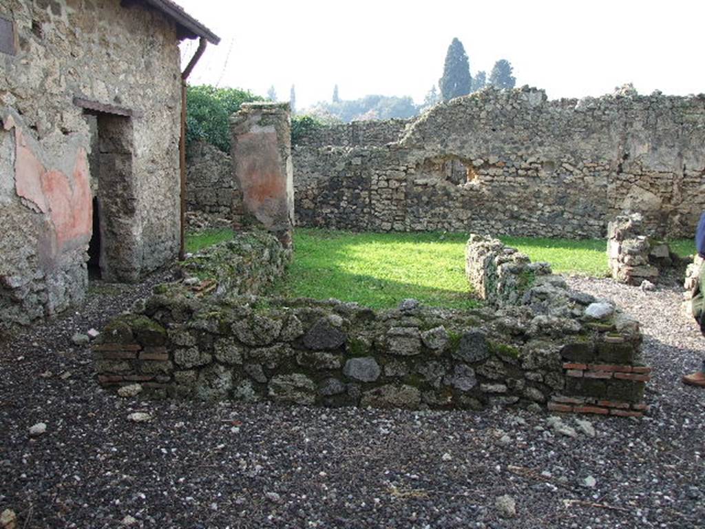 I.3.25 Pompeii. December 2006. Looking west across 3-sided pseudoperistyle to garden area. According to Schefold, on the south-west corner pillar there was a painting of a flying Isis Fortuna with a horn of plenty and a globe. See Schefold, K., 1957. Die Wnde Pompejis. Berlin: De Gruyter. (p. 13).
According to Trendelenburg, this small rectangular peristyle was open to the west side onto a small garden area. The other three sides were surrounded by a low podium of material, on which rested four brick columns, originally faced with coloured stucco. The peristyle was being restored at the time of the catastrophe in 79AD. The podium on the left side ended with a large pilaster. This surviving pilaster, on a background of red stucco, showed a different type of female flying figure (height I.15m). She was naked, except for a transparent yellow mantle, covering her from her breast to her knees. In her right hand she held a wreath or crown of laurel, in her left was a cornucopia. At her feet was a globe.
See Trendelenburg in BdI 1871 (p.173) 
According to Sogliano, Nike (Victory) with a yellow transparent veil painted on a red background, was found on the corner pilaster in the south-west corner of the peristyle.
See Sogliano, A., 1879. Le pitture murali campane scoverte negli anni 1867-79. Napoli: Giannini. (p.72, no.431) 
