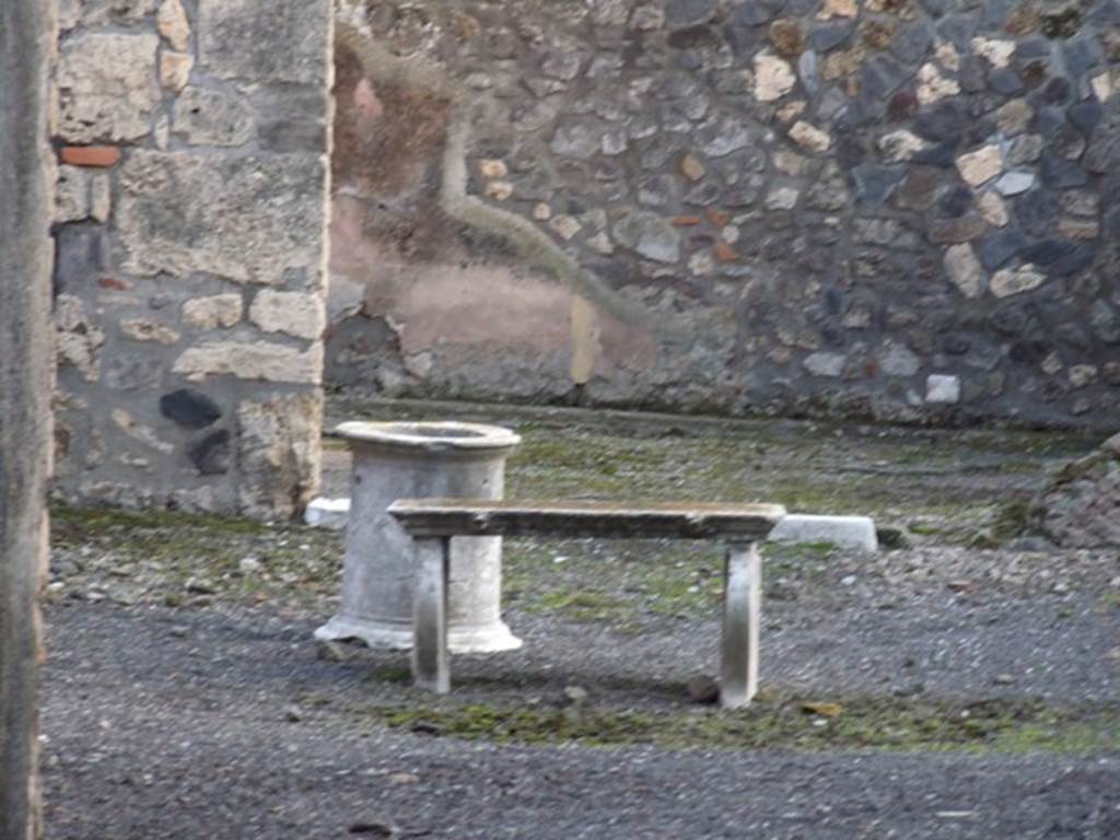 I.4.22 Pompeii. December 2007. 
Looking south across atrium, with marble puteal, marble table and remains of impluvium, towards courtyard.
According to PPM –
Behind the impluvium, whose coating (probably of marble) was removed after the 79AD eruption, the marble table was found near the lava mouth of the cistern.
See Carratelli, G. P., 1990-2003. Pompei: Pitture e Mosaici.I. Roma: Istituto della enciclopedia italiana, (p. 183).

