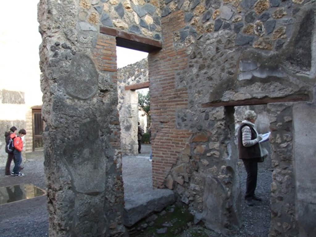 I.4.25 Pompeii. December 2007.
Room 50, room on west side of atrium with three doorways, south-east corner showing three doorways.