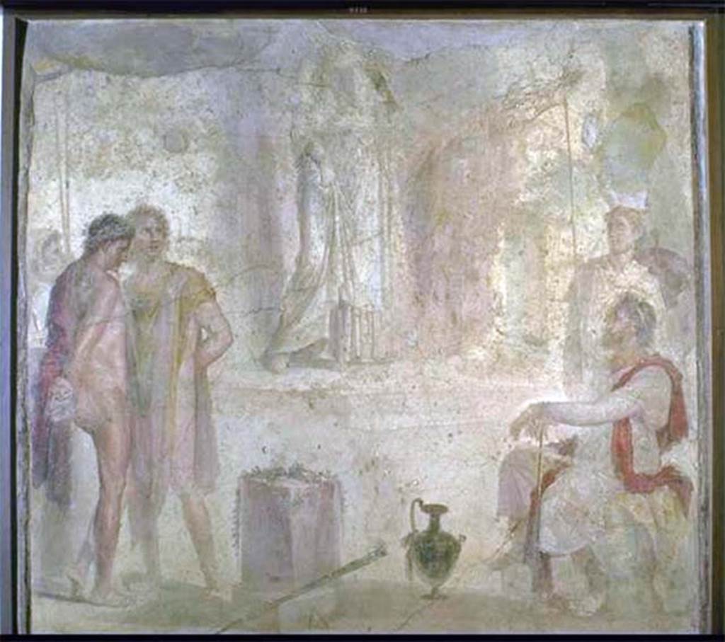 I.4.25 Pompeii. Found 1869. Room 35, east wall of exedra. Wall painting of Iphigenia in Tauris with Thoas, Orestes and Pylades.
According to Helbig, Thoas sits on the right on a stone seat covered with a leopard skin. 
Behind him, is a guard wearing a Phrygian cap and bearing a shield in his left hand.
Orestes wearing a red cloak looks melancholy.
Pylades, wearing a yellow and light purple cloak, looks livelier, a mixture of fear and defiance.
A second guard, with face covered and holding two spears, stands behind the prisoners.
At the rear is a staircase that leads to a temple platform on which Iphigenia moves slowly towards the stairs.
The top of the picture is destroyed but it is likely she is looking towards the visitors. 
She is probably carrying the Tauran Artemis idol on her left shoulder.
Now in Naples Archaeological Museum. Inventory number 9111.
See Helbig, W., 1868. Wandgemälde der vom Vesuv verschütteten Städte Campaniens. Leipzig: Breitkopf und Härtel, 1333, p. 295-6.

