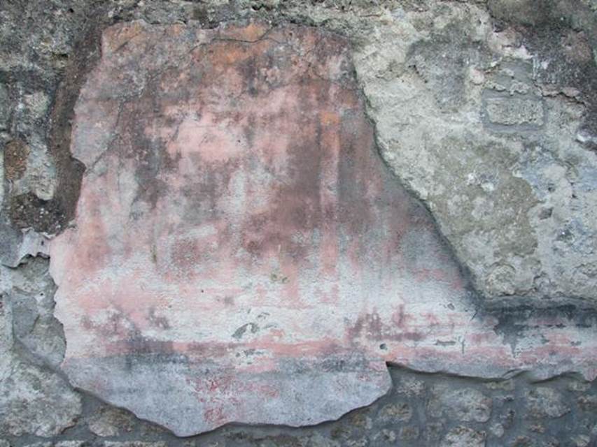 I.4.25 Pompeii. December 2007. Exedra 18, remains of painted wall plaster from south wall.