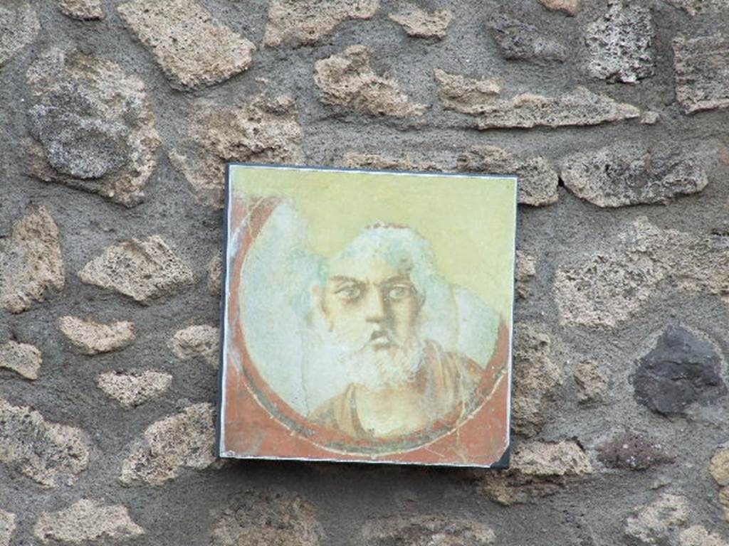 I.4.25 Pompeii. December 2006. 
Room 18, exedra on west side of middle peristyle 17, reproduction of wall painting of an old man with a grey beard.
