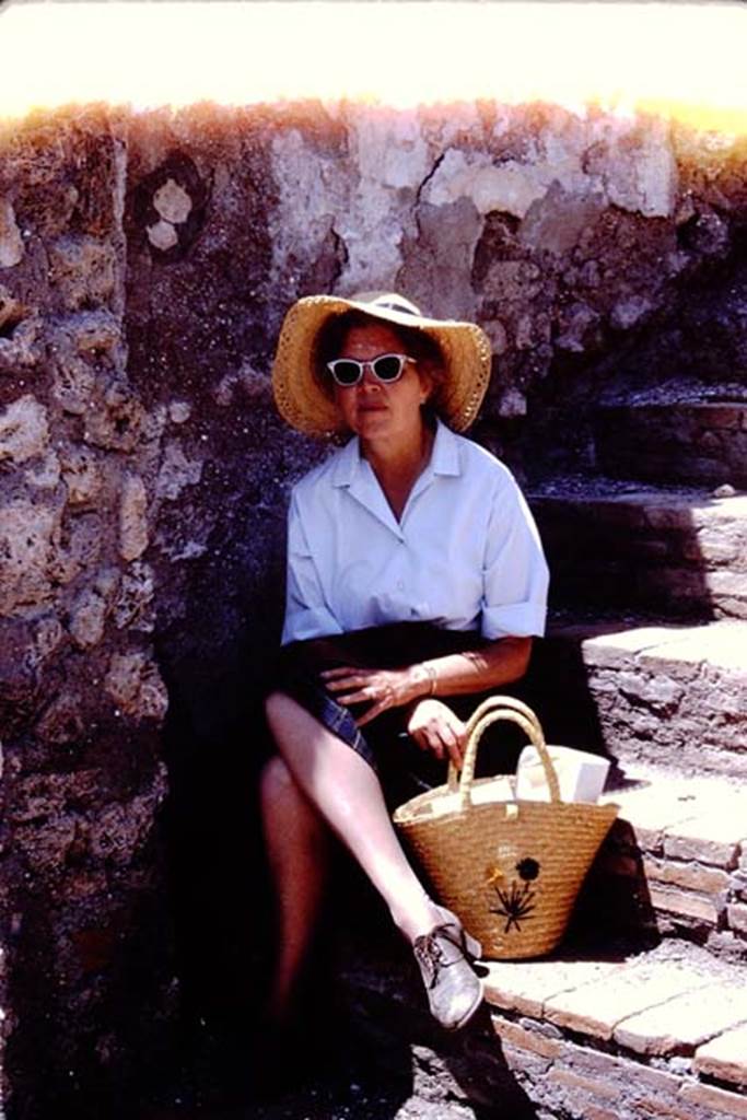 I.4.25 Pompeii. 1966. Wilhelmina resting in the shade on the stairs between peristyles. 
Photo by Stanley A. Jashemski.
Source: The Wilhelmina and Stanley A. Jashemski archive in the University of Maryland Library, Special Collections (See collection page) and made available under the Creative Commons Attribution-Non Commercial License v.4. See Licence and use details.
J66f0558
