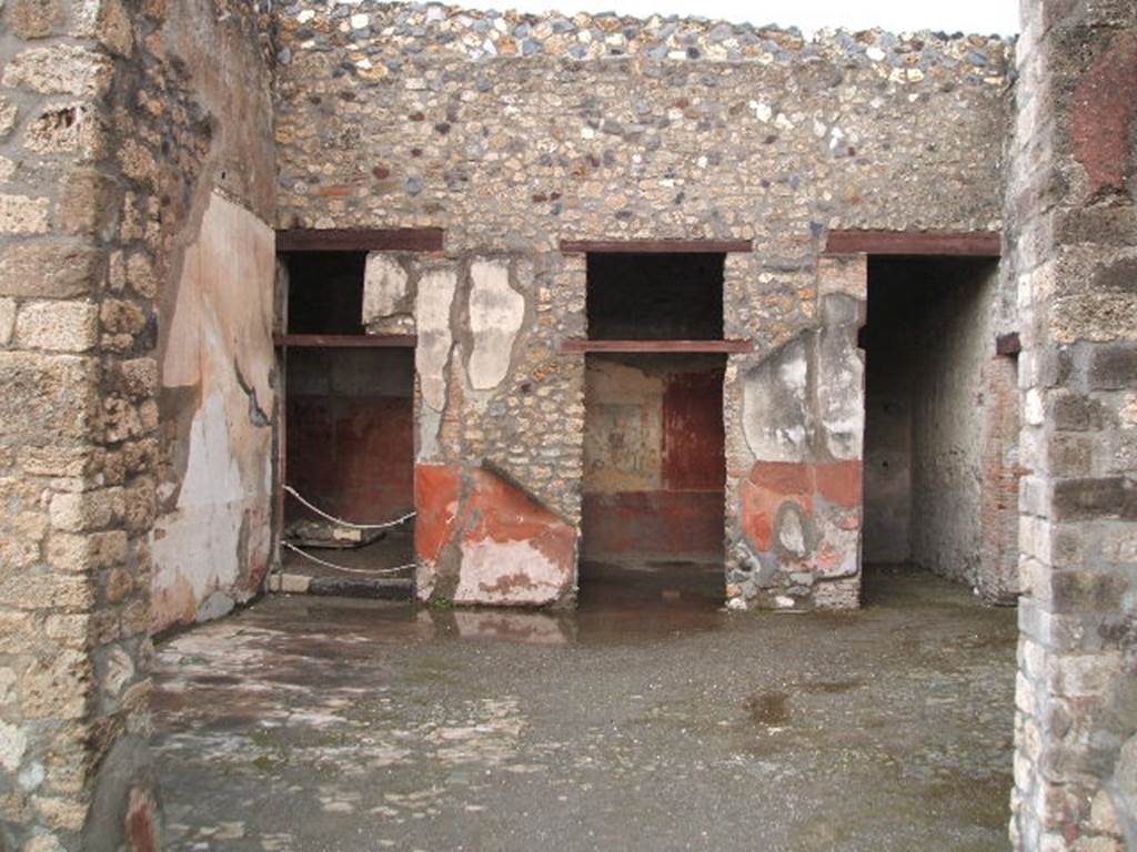 I.4.25 Pompeii. December 2004. Room 21, oecus of the Judgement of Paris. Doorways to rooms 22, 23, and 24 on the east side.