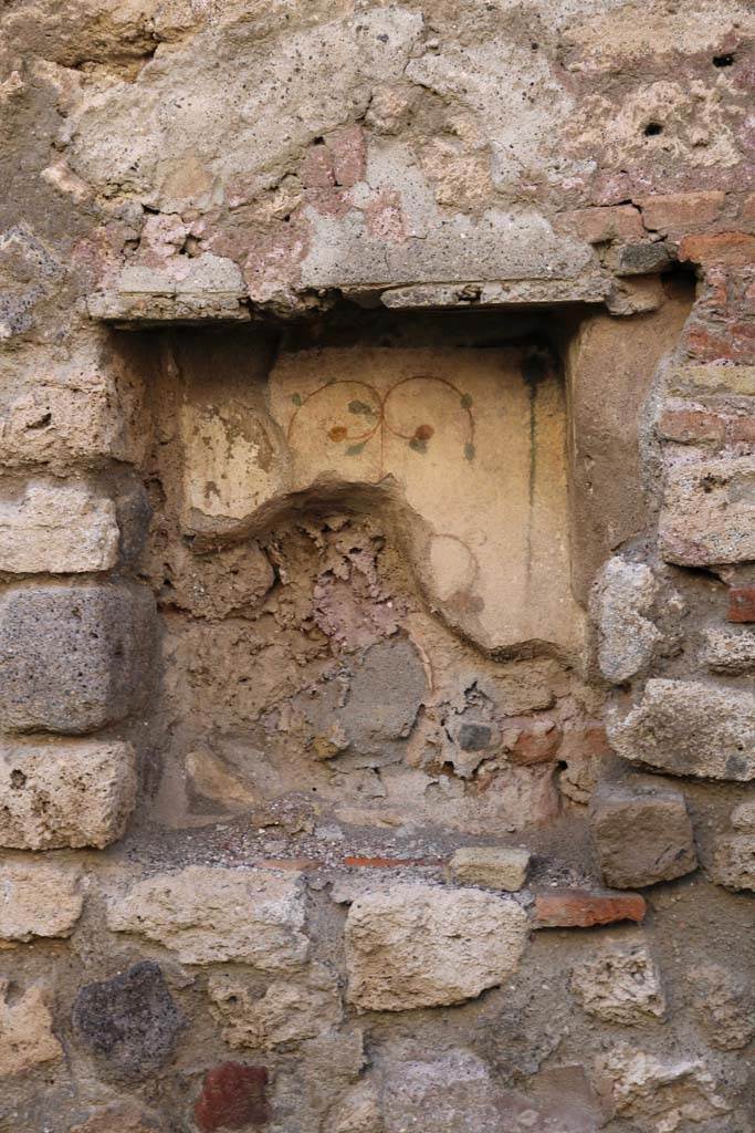 I.6.1 Pompeii. December 2018. West wall with rectangular niche. Photo courtesy of Aude Durand.
According to Boyce –
In the west wall is a rectangular niche (h.0.54, w.0.45, d.0.25, h. above floor 0.80).
Its walls were coated with white stucco and decorated with leaves and fruit, painted in red, green and yellow.
He quotes -  Not Savi, 1913, 477.
See Boyce G. K., 1937. Corpus of the Lararia of Pompeii. Rome: MAAR 14.  (p. 25, no.35).
