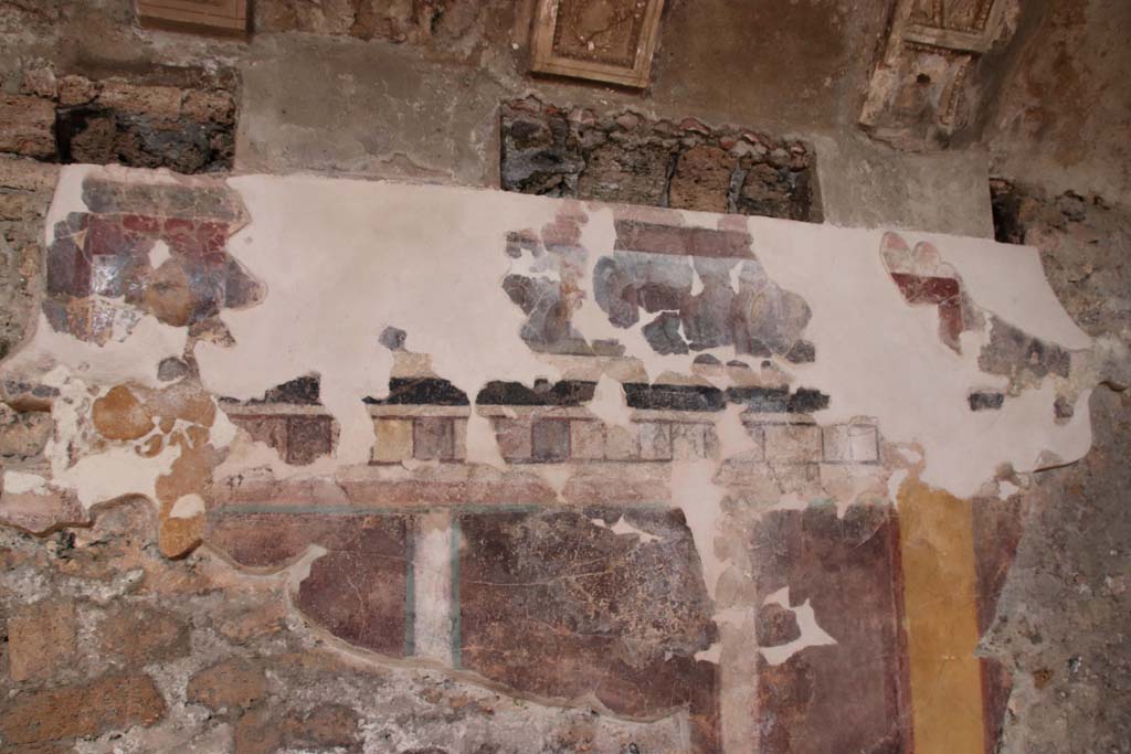 I.6.2 Pompeii. September 2019. Detail from north wall of north wing of cryptoporticus. Photo courtesy of Klaus Heese.
According to PPM, this frieze continues to show scenes from the Iliad. 
On the left is the head of a maenad.
After a gap, the iliac narrative continues with the exchange of weapons between Glaucus and Diomedes, whose name is recorded at his feet in Greek.
On the right, is a fighter on a chariot, assisted by a cloaked figure. 
Diomedes can be recognized, who, assisted by Athena, fights Ares or Aeneas.
See Carratelli, G. P., 1990-2003. Pompei: Pitture e Mosaici: Vol. I.  Roma: Istituto della enciclopedia italiana, p. 204. 
