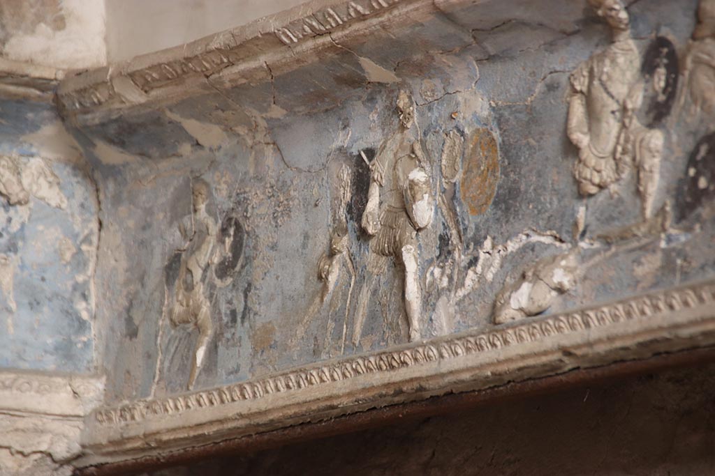 I.6.4 Pompeii. October 2024. Room 16, Group of Achaean warriors.
Detail from frieze on west wall of sacellum at south end. Photo courtesy of Klaus Heese.
