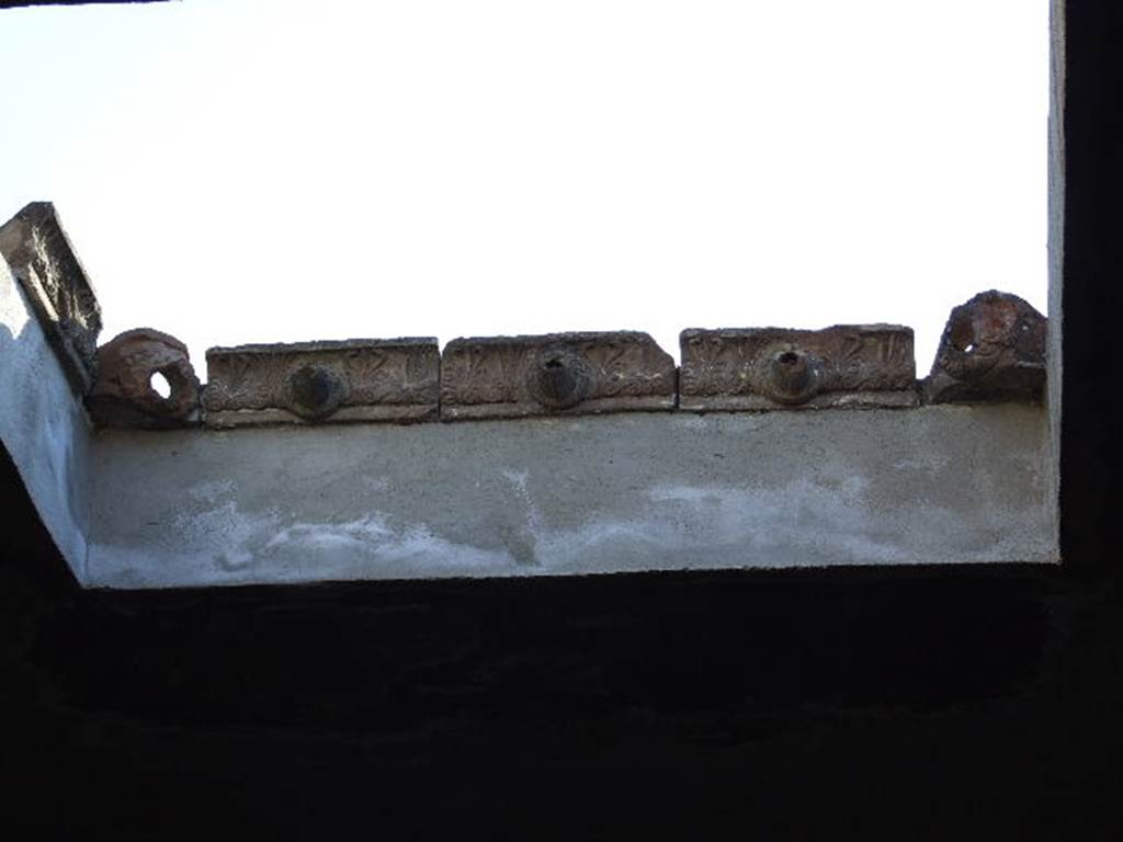 I.6.7 Pompeii. December 2006. Atrium. Reconstructed compluvium with original terracotta water spouts, through which the rain water fell into the impluvium.