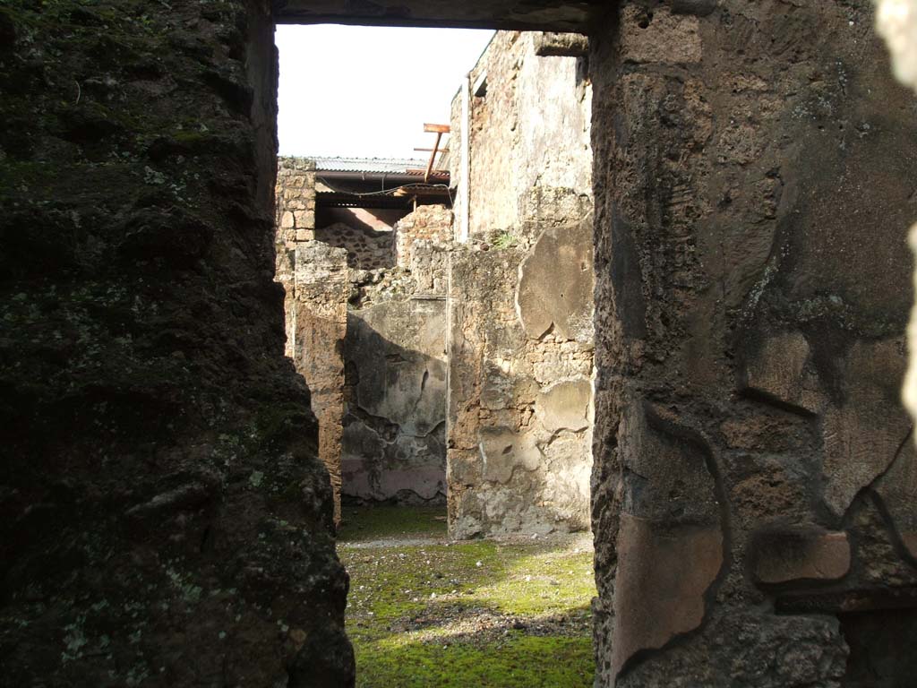 I.6.13 Pompeii. December 2004. Looking across room on east side of entrance with stairs (I.6.14) against west wall. 
Looking north-east towards doorway of cubiculum (5). 
