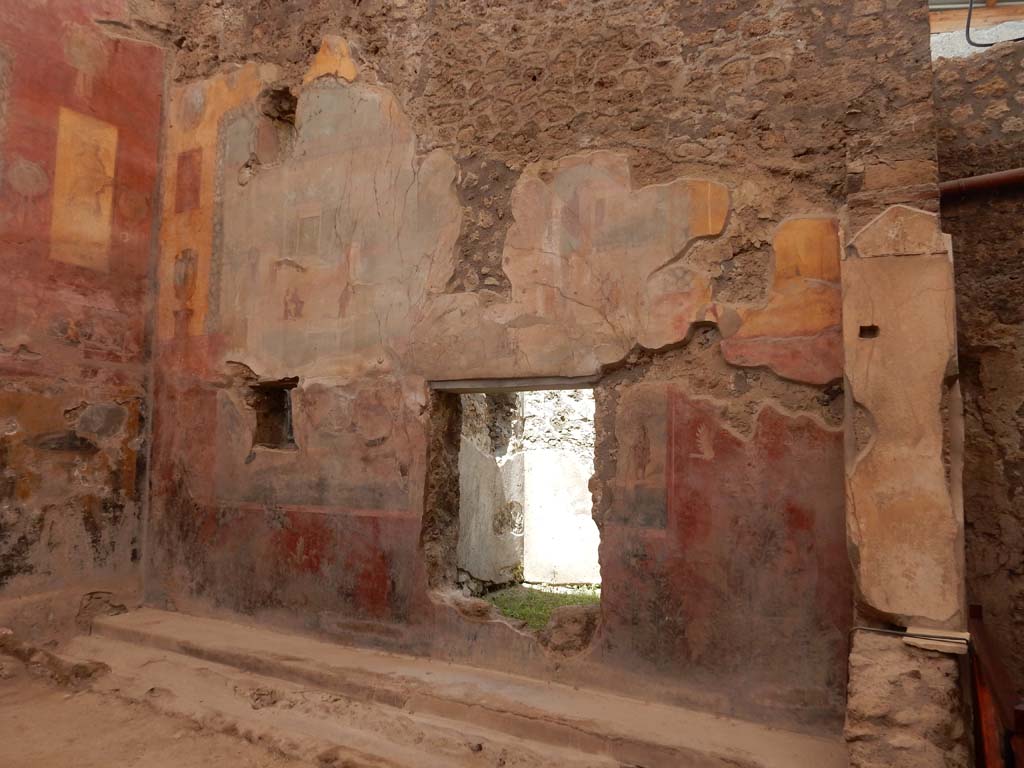 I.6.15 Pompeii. June 2019. Room 9, east wall of small garden, with window to room 10.
Photo courtesy of Buzz Ferebee.