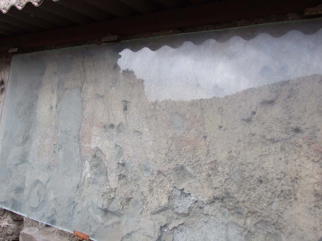 I.7.7 Pompeii. December 2006. 
West wall of vestibule with remains of ancient combat wall painting with Oscan inscriptions.
This came to light when a good part of the wall plaster fell, revealing beneath it, the ancient painting of figures with traces of inscriptions.
Above a figure fleeing on horseback to the right, was written in Oscan – “SPARTAKS”.
Badly mutilated but above the figure of the horseman chasing him, was written “PHELI…..ANS”.
See Notizie degli Scavi di Antichità, 1927, 21, Abb 5.

Jacobelli described it as being 2.06 m long and 0.45m high.
On the far right a figure with the head of an animal is playing a long trumpet.
Two fighters on horseback, armed with round shields. One pursues the other and wounds him with a long lance.
Above the attacker is an Oscan inscription Phili[….] ans, interpreted as Phili[ks pumpaii]ans . Above the wounded horseman is the name Spartaks.
On the left is a duel between two dismounted gladiators (possibly Samnites) armed with swords and rectangular shields.
There are undecipherable Oscan inscriptions above their heads.
At the left end is a structure which may possibly be an altar.
One theory is that it showed the death of Spartacus following a wound on the thigh as described in ancient sources.
A second theory is that it predates the revolt of Spartacus and shows a gladiatorial spectacle with a gladiator called Spartacus which was a common name amongst Thracians.
See Jacobelli, L., 2003. Gladiators at Pompeii. Roma: L’Erma di Bretschneider. (p.75, fig 62)
