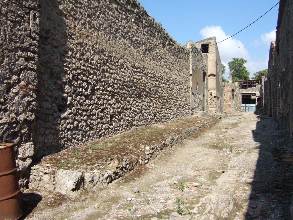 I.7.12 Pompeii, on left. September 2005. Raised pavement outside in vicolo, looking north.