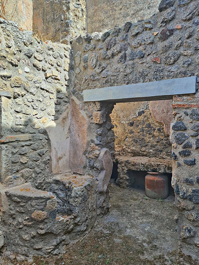 I.7.19 Pompeii. September 2024.
Looking north-east in second small room on north side of corridor, with doorway to kitchen area, on right.
Photo courtesy of Giuseppe Ciaramella.