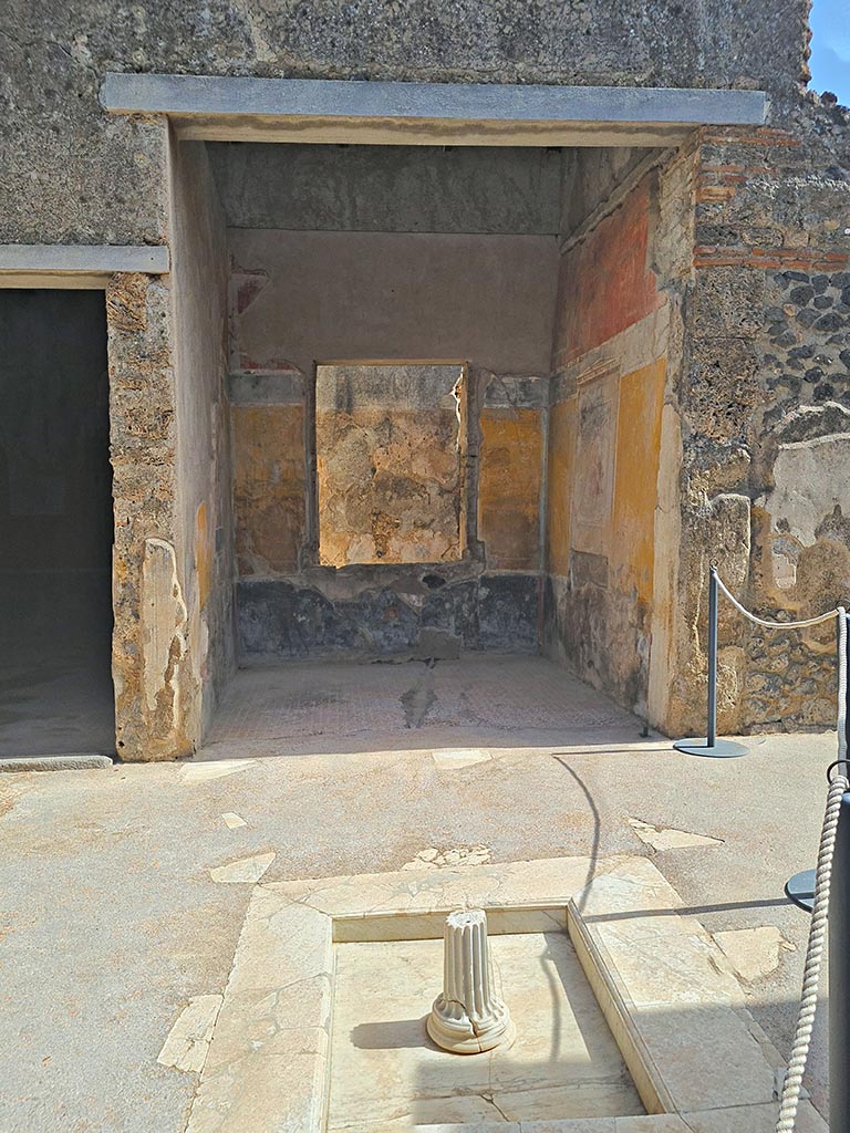 I.7.19 Pompeii. September 2024. 
Looking east across impluvium in atrium towards tablinum. Photo courtesy of Giuseppe Ciaramella.
