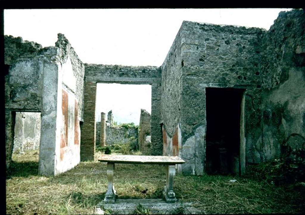 I.8.5 Pompeii. Looking south from impluvium towards tablinum and garden.
In the room with the doorway on the right, (south-west corner of atrium) a ship graffiti was seen on the white west wall of the cubiculum.  At the rear of the garden was the triclinium. Photographed 1970-79 by Gnther Einhorn, picture courtesy of his son Ralf Einhorn.

