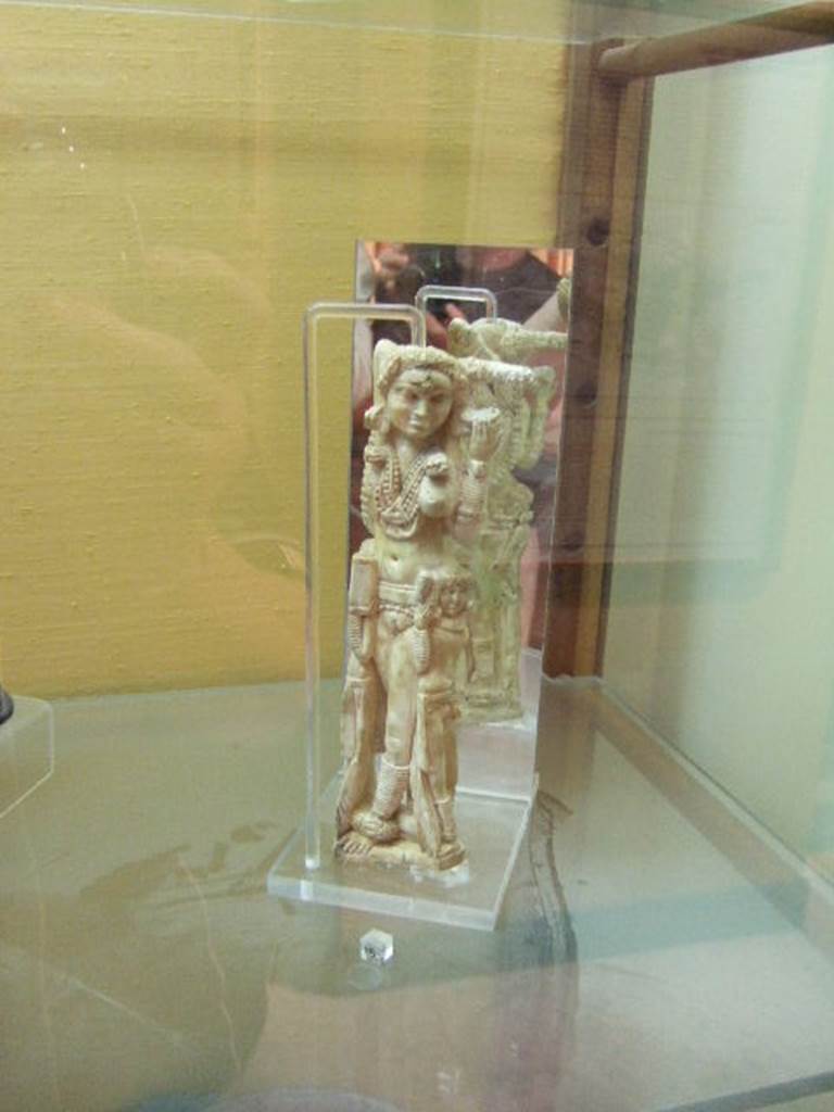 I.8.5 Pompeii. Ivory statuette of Lakshmi.  Found in a wooden chest on the west side of the Viridarium 8.  Now in Naples Archaeological Museum. Inventory number 149425. According to Jashemski, Della Corte stated that the small Indian statuette was found October 24th 1938 in the nearby I.8.19. He thought it had been thrown down, when the south-west corner of the peristyle of this house had collapsed. Maiuri said that the statuette had been stored in a wooden chest in one of the rustic rooms off the portico, together with various objects of domestic use.
Maiuri Statuette eburnean darte Indiana a Pompeii, Le arti (1938) pp 111-115.  Della Corte, M., 1965.  Case ed Abitanti di Pompei. Napoli: Fausto Fiorentino.(p.333-4).  See Jashemski, W. F., 1993. The Gardens of Pompeii, Volume II: Appendices. New York: Caratzas. (p.42)
According to Berry, the statuette was found in the House of the Four Styles (I.8.17).  See Berry, J., 2007. The Complete Pompeii. London, Thames & Hudson, (p.200)
