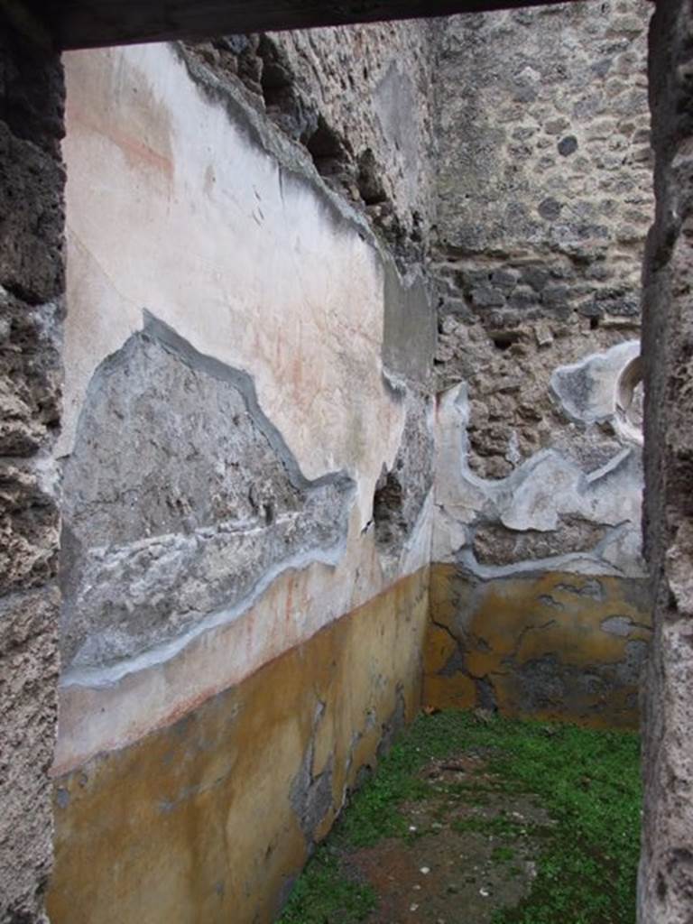 I.8.14 Pompeii. December 2007. 
Room 5, cubiculum on east side of atrium, looking east along north wall towards north-east corner.
A high yellow plinth; white middle area: panels framed in red, with vignettes (a swan at the west end, Pegasus in the centre, the east end one has disappeared) and carpet borders (triangles in the central panel, drops in the lateral ones) separated by white compartments with golden candelabra. IV style.
See/Vedi Carratelli, G. P., 1990-2003. Pompei: Pitture e Mosaici: Vol. I. Roma: Istituto della enciclopedia italiana, p. 838.


