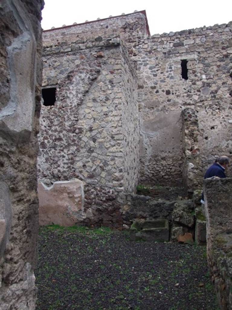 I.8.14 Pompeii. December 2007. 
Room 7, courtyard area, looking north through doorway from atrium towards north-east corner of courtyard.
At the rear of the fallen wall is the latrine (11).  

