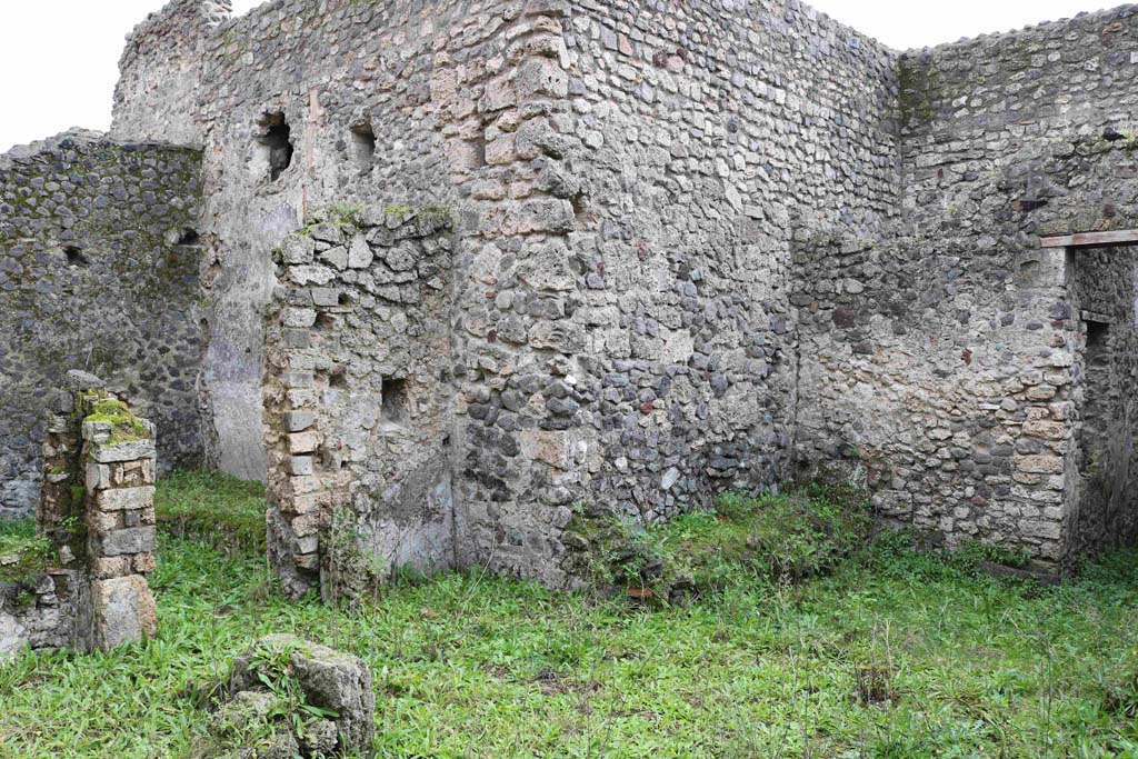 I.8.16 Pompeii. December 2018.
Looking south-east across room/garden towards doorway to kitchen area, on left, and to a triclinium, on right.
The doorway, on the right, would have led into one of the rear rooms of I.8.15. 
This doorway may have led into a triclinium for the clients. Photo courtesy of Aude Durand.
