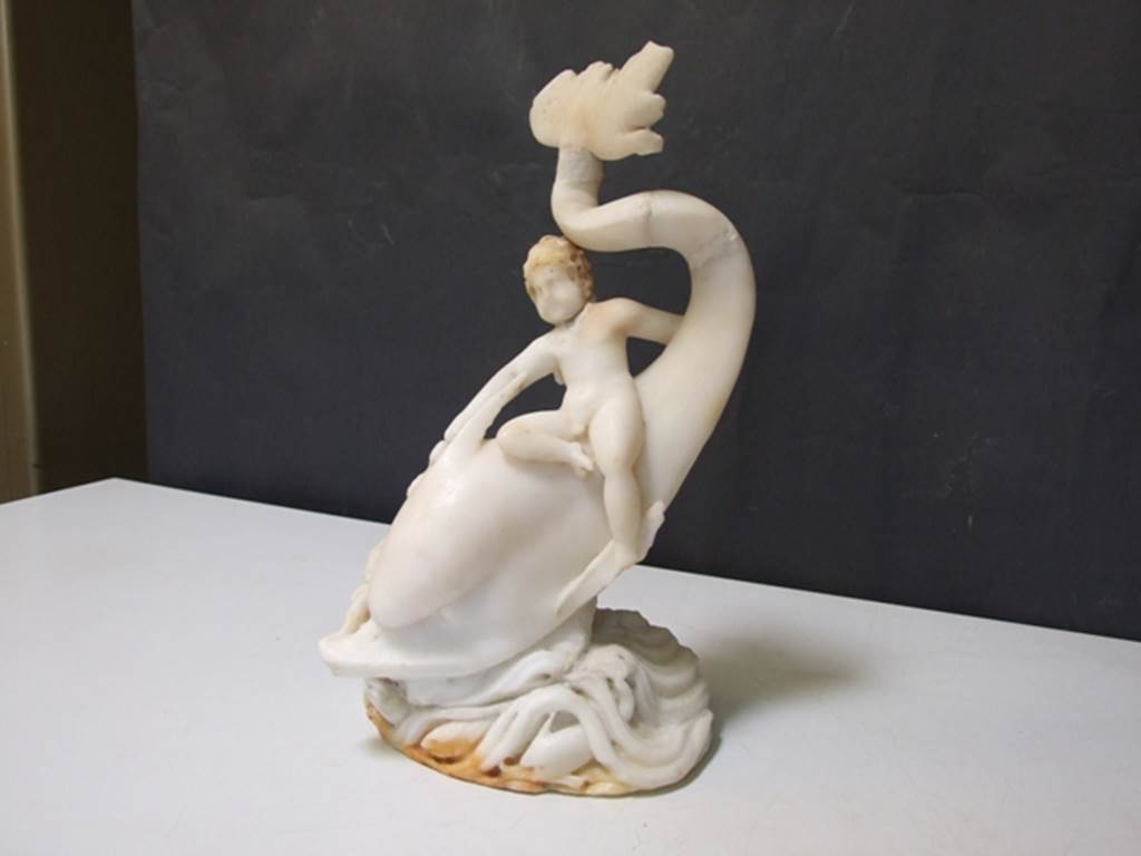 I.9.14 Pompeii. Marble fountain statuette. Amorino on dolphin with octopus. SAP inventory number 8126. Found in 1951.