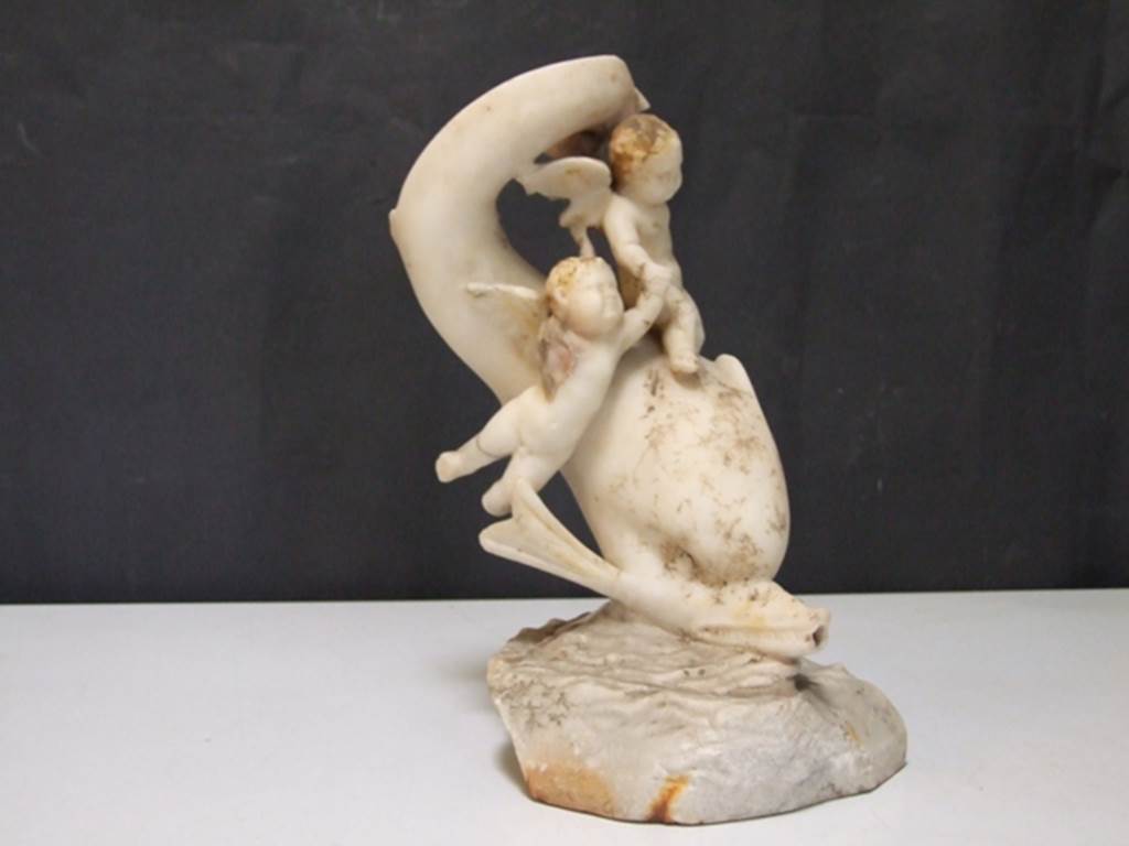 I.9.14 Pompeii. Marble fountain statuette. Two Amorini riding on dolphin. SAP inventory number 8128. Found in 1951.