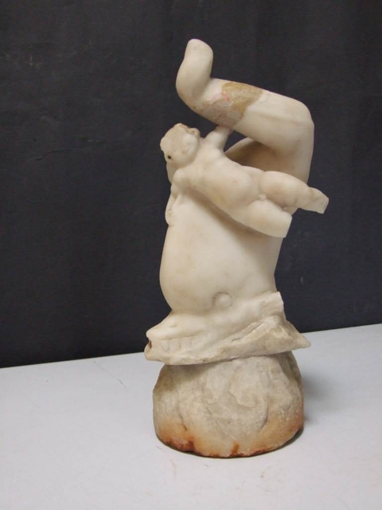 I.9.14 Pompeii. Marble fountain statuette. Amorino riding on dolphin. SAP inventory number 8129. Found in 1951.